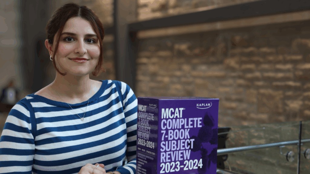 Isabell Kearn holding MCAT preparation books associated with the McMaster MCAT Book Drive.