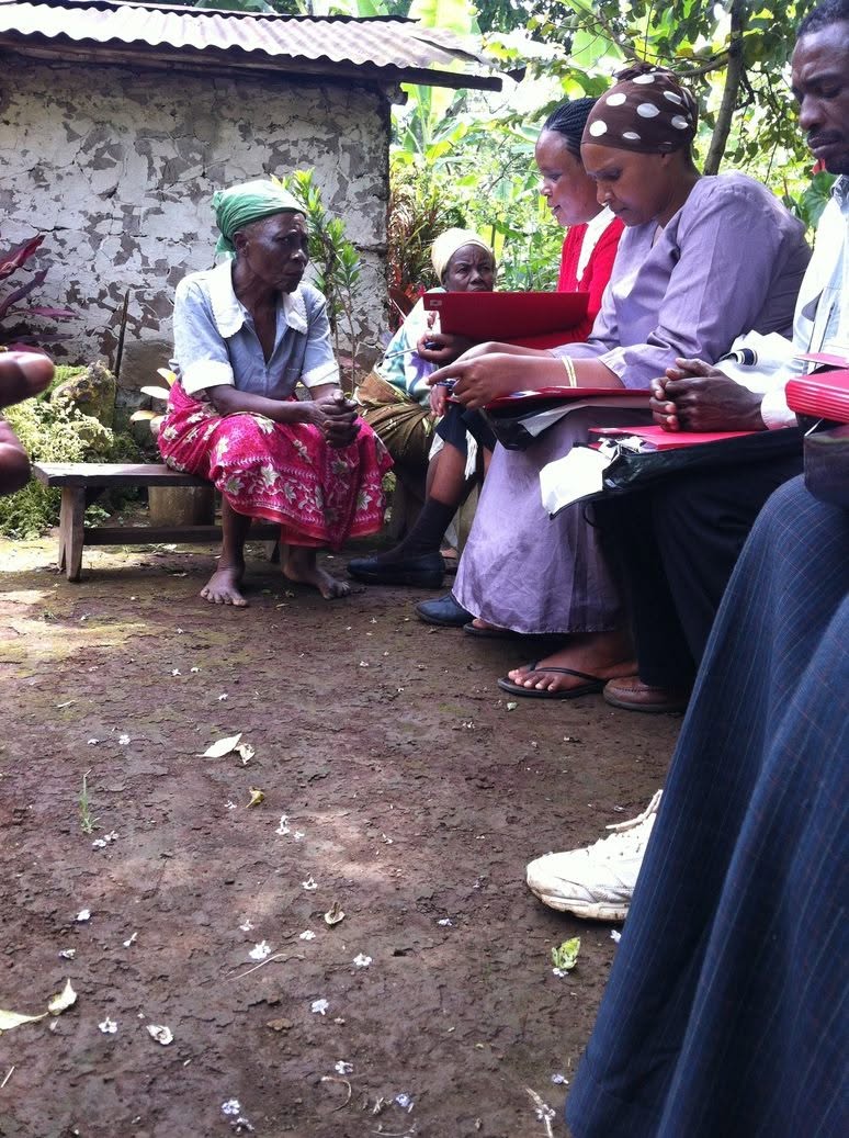 Dream Global team members speaking with community members in Kisiki.