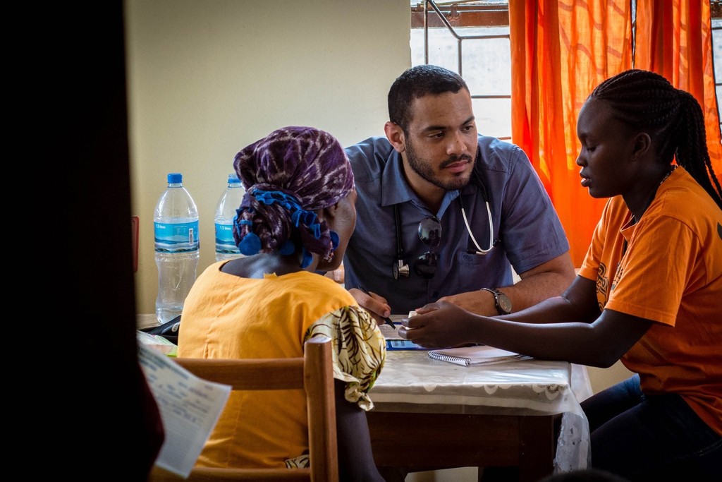Queen’s medical students meeting community members during outreach.